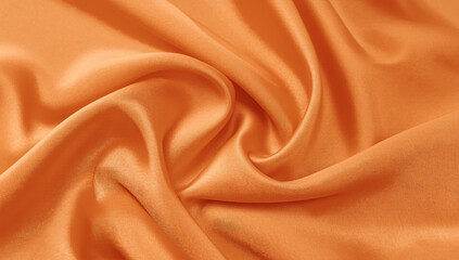 Fototapeta premium Vibrant Orange Draped Fabric Background with Smooth Texture and Soft Lighting for Elegant Display