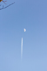 moon and contrail in the sky