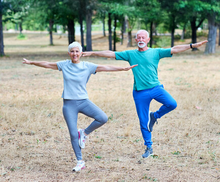 Portrait os a happy beautiful elderly senior mature couple exercising and stretching outdoors - Powered by Adobe