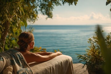 Fototapeta premium Relaxation at a tranquil spa overlooking the ocean, with a woman enjoying wellness under the sun and surrounded by lush nature