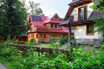 ZAKOPANE, POLAND - JULY 29, 2025: Traditional Podhale housing. Wooden houses set amidst beautiful gardens.
