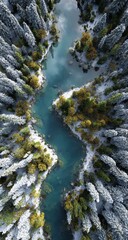 Aerial view of a winding river flowing through a snowy, forested valley