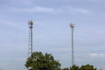 telecommunication  towers stand against a sky, modern wireless communication. for broadcasting 6G, 5G, and signals for telecommunications infrastructure, and the expansion of digital connectivity.