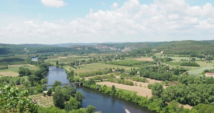 Bucolic landscapes of Dordogne Valley with the River and its meanders seen from the Domme esplanade towards La Roque-Gageac and Beynac-et-Cazenac at the foot of their limestone cliffs

