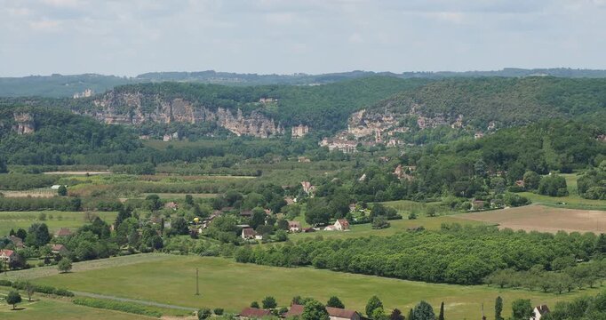 Verdant landscapes of Dordogne Valley. The limestone cliff at the foot of which lies the village of La Roque-Gageac, further on the Ch&acirc;teau de Beynac overlooking the Dordogne
