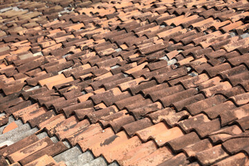 The roof is made of red tiles and has a worn appearance