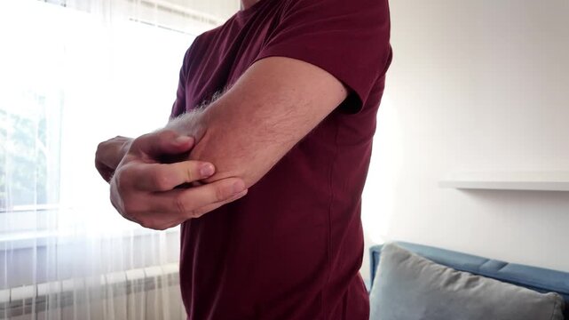 Man with elbow pain at home.