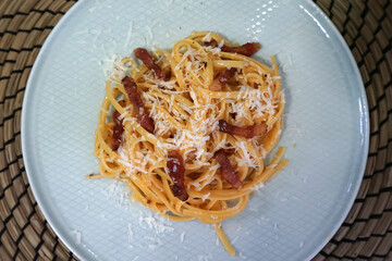 Close up plate of Carbonara Fettucine pasta with crispy bacon bits