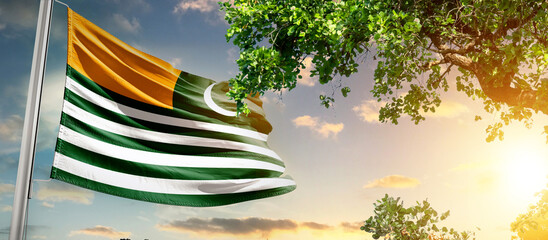 Kashmir national flag waving in the sky behind the tree. The flag blow in beautiful sunlight. 5th febuary Kashmir national flag for solidarity day.