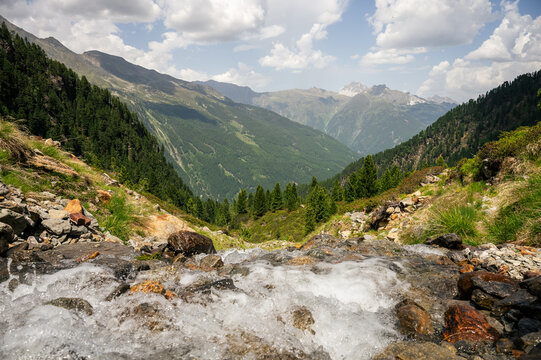 Mountain stream flowing through alpine valley in summer Austria