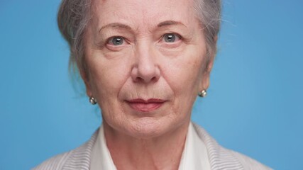 Confident elderly woman staring into camera
