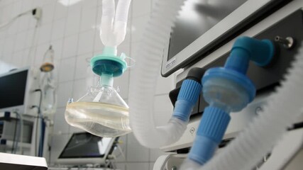 Medical anesthesia equipment in a bright operating room, featuring ventilator tubing and a mask, showcasing advanced surgical technology and sterile environment for patient care	