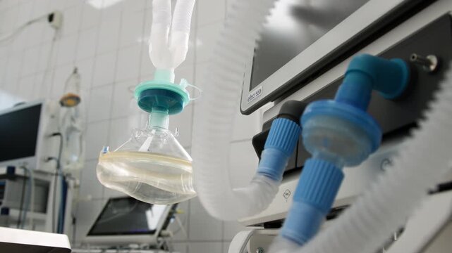 Medical anesthesia equipment in a bright operating room, featuring ventilator tubing and a mask, showcasing advanced surgical technology and sterile environment for patient care	