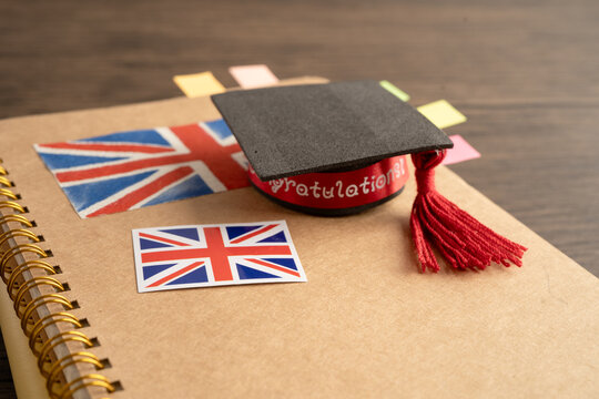 UK flag with graduate hat on english language book.