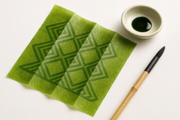 Sustainable seaweed-based packaging sheet with geometric print, resting on white background with soy ink and eco brush – minimal and clean visual for green product branding.