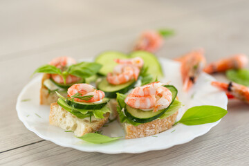 Light festive canapes with seafood, greens and fresh vegetables
