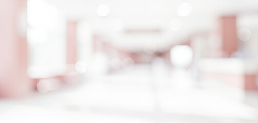 Blurred background of a bright interior space with white and pale pink tones, creating a soft, minimal ambiance filled with gentle light and quiet atmosphere.