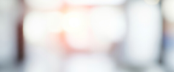 Abstract blurred background featuring white light and soft pastel colors that create a tranquil, luminous ambiance.