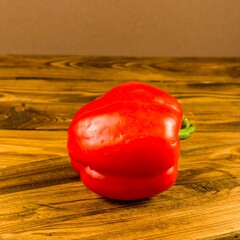 Red bell pepper on wooden table