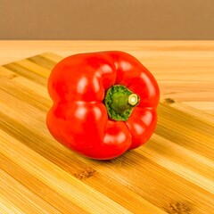 Red bell pepper on wooden cutting board (1)
