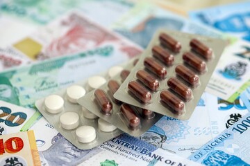 Nigerian naira currency money bills and medicine pills. The concept of medicine and pharmacy