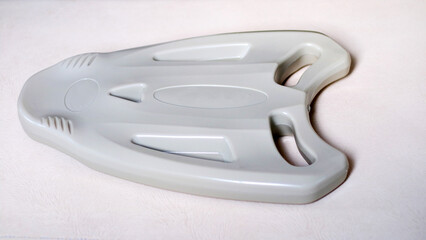 Plastic float board to help practice swimming.