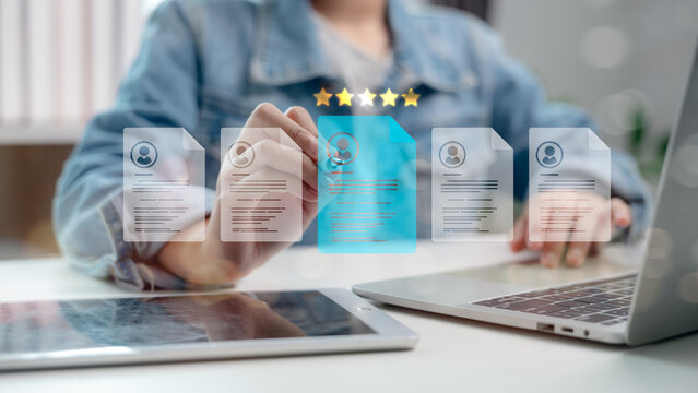 Human resource manager analyzing digital resumes with five-star rating system, selecting best candidate using AI technology and data-driven recruitment process.