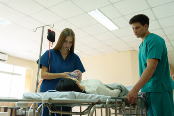 Doctors and nurses are caring for a patient lying in a wheelchair who is in critical condition.