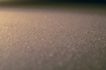 White micro dust on black background. Texture grunge background with tiny white dust. Home cleaning concept.
