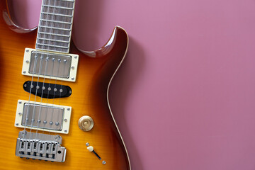 Electric guitar on purple table background, close up music concept