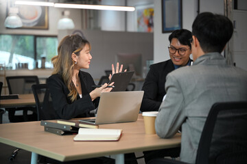 Team of professionals having a discussion in a modern office, collaborating on a project