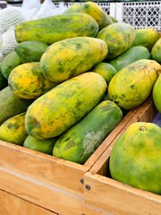 Wooden crate overflowing with ripe papayas, a tropical treasure trove.