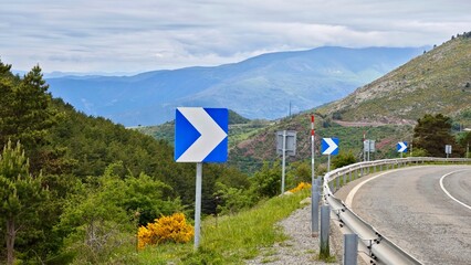 Panoramic view of the road in the mountains. Travelling by car.Winding mountain road with metal...