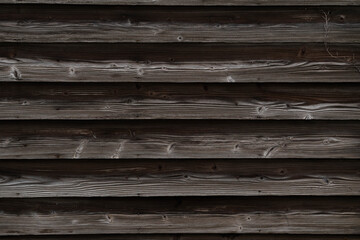 The exterior wall of a house made of black wooden planks in Yatsushiro city, Japan.