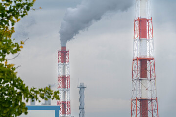 Smoke is coming out of the factory's chimney on the outskirts of Yatsushiro City, Japan.