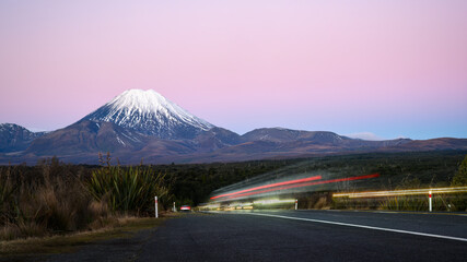 Long exposure image of busy traffic motion. Road to Mt Ngauruhoe at dusk. Tongariro National Park. New Zealand.