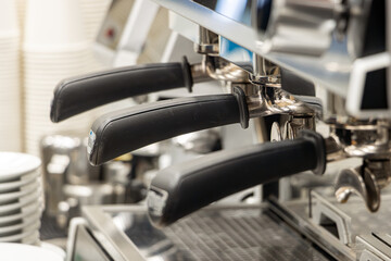 Close-Up of Professional Espresso Machine Handles in Coffee Shop Setting