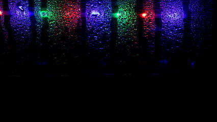 abstract background of watery glass reflected by colorful lights