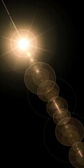 A bright light source with lens flare effect on a dark background with bubbles