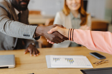 Close up of handshake during business agreement in office