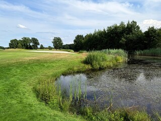 vivid pond reflection on the golf course