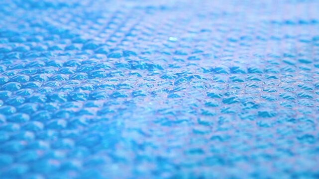 The blue coating of the pool, reflecting sunlight, emphasizes summer recreation and pool maintenance.
