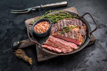 Grilled Rib eye prime steak, roasterd dry aged beef meat. black background. top view