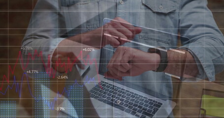 Reviewing financial overlays woman tapping smartwatch and holding tablet at wooden desk with laptop