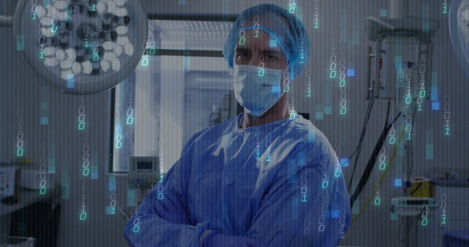 Standing surgeon wearing mask, hairnet, blue gown under lights in OR, with floating binary code