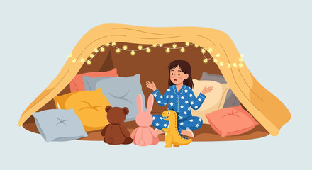 Excited Girl In Starry Pajamas Plays In A Cozy Pillow Fort With Toys