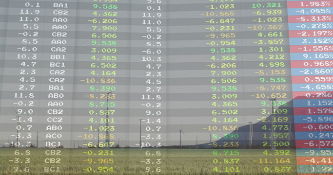 Showing wind turbines standing on rural farmland, with overlaid colored data codes and smokestacks