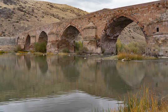 Ancient bridge reflecting on calm river waters in kirikkale, turkey