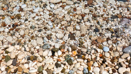 Pebbles on a beach washed by undertow water