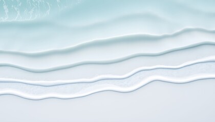 Fototapeta premium Abstract aerial view of gentle ocean waves washing ashore, creating a calming and serene scene.